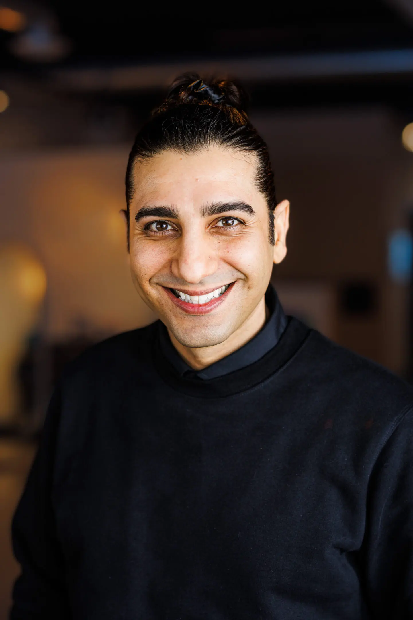 Smiling person in a black sweater