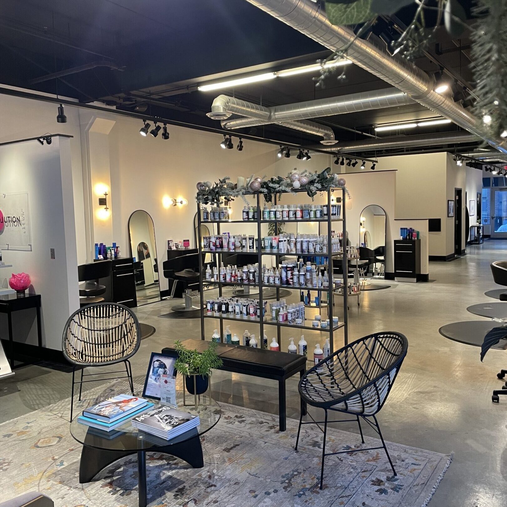 Modern, stylish salon interior with chic furniture and bright lighting.