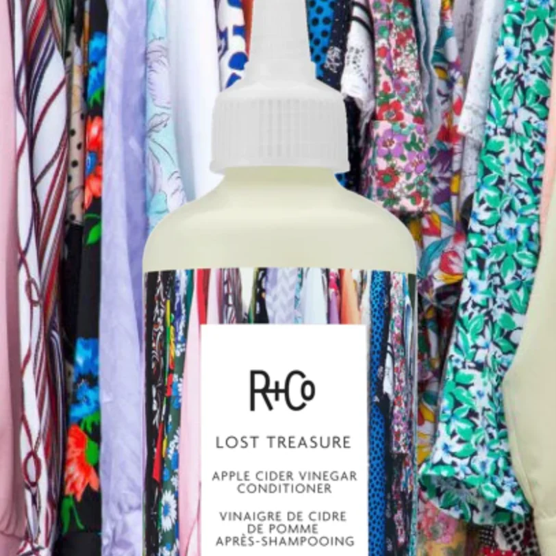 R+Co conditioner amidst vibrant clothing display
